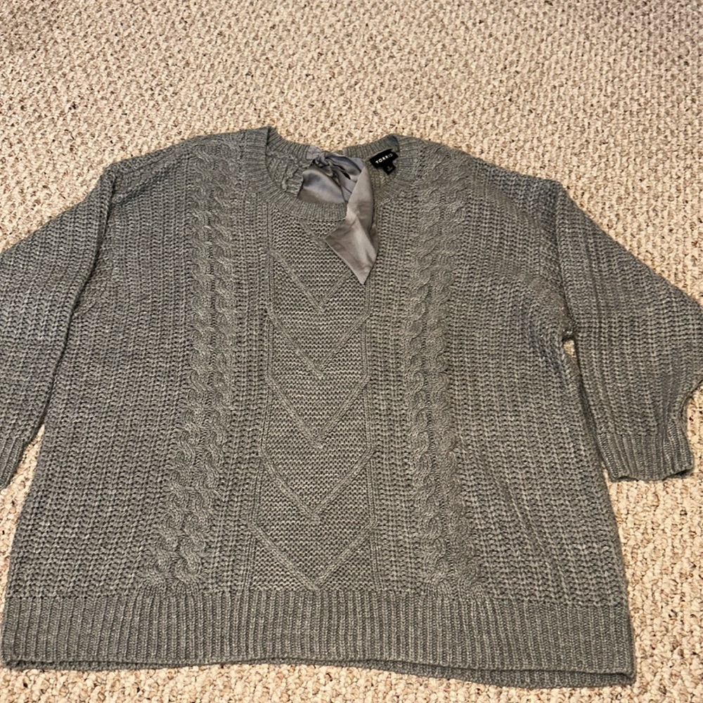 Grey sweater with a bow on the back